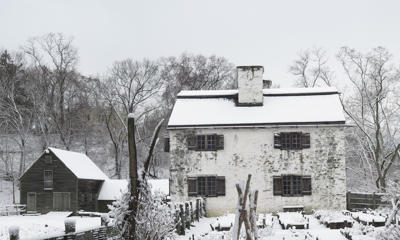 The manor house and mill in the snow at Philipsburg Manor
