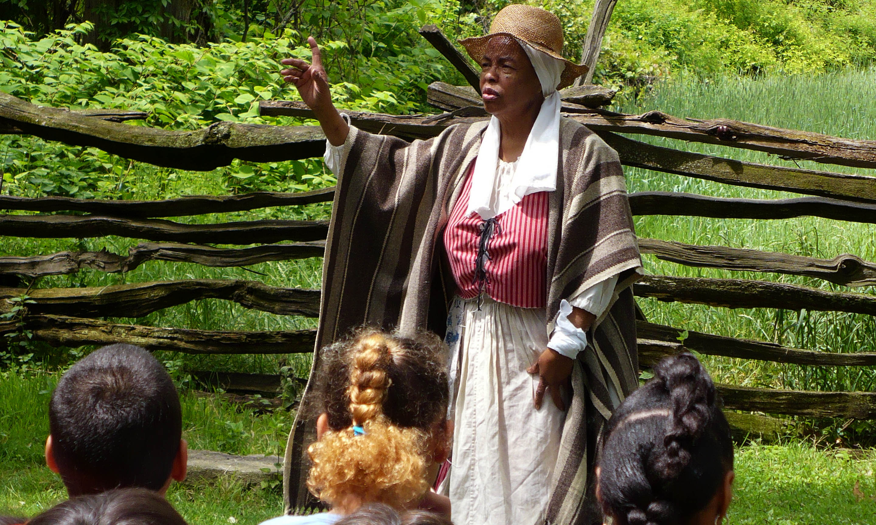 Students engage with a storytelling performance at Philipsburg Manor